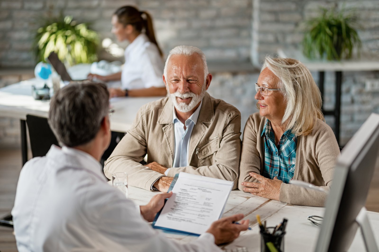 An older couple discussing coverage with a healthcare adviser